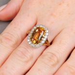 An orange topaz and diamond cluster ring.Topaz calculated weight 5.18cts,