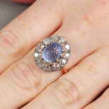 A foliate carved sapphire and old-cut diamond cluster ring.Sapphire weight 5.39cts.Estimated total