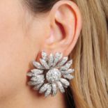 A pair of pave-set diamond flower earrings.