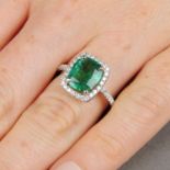A cushion-shape emerald and brilliant-cut diamond cluster ring.