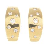 A pair of 18ct gold diamond hoop earrings.Estimated total diamond weight 0.40ct.Hallmarks for