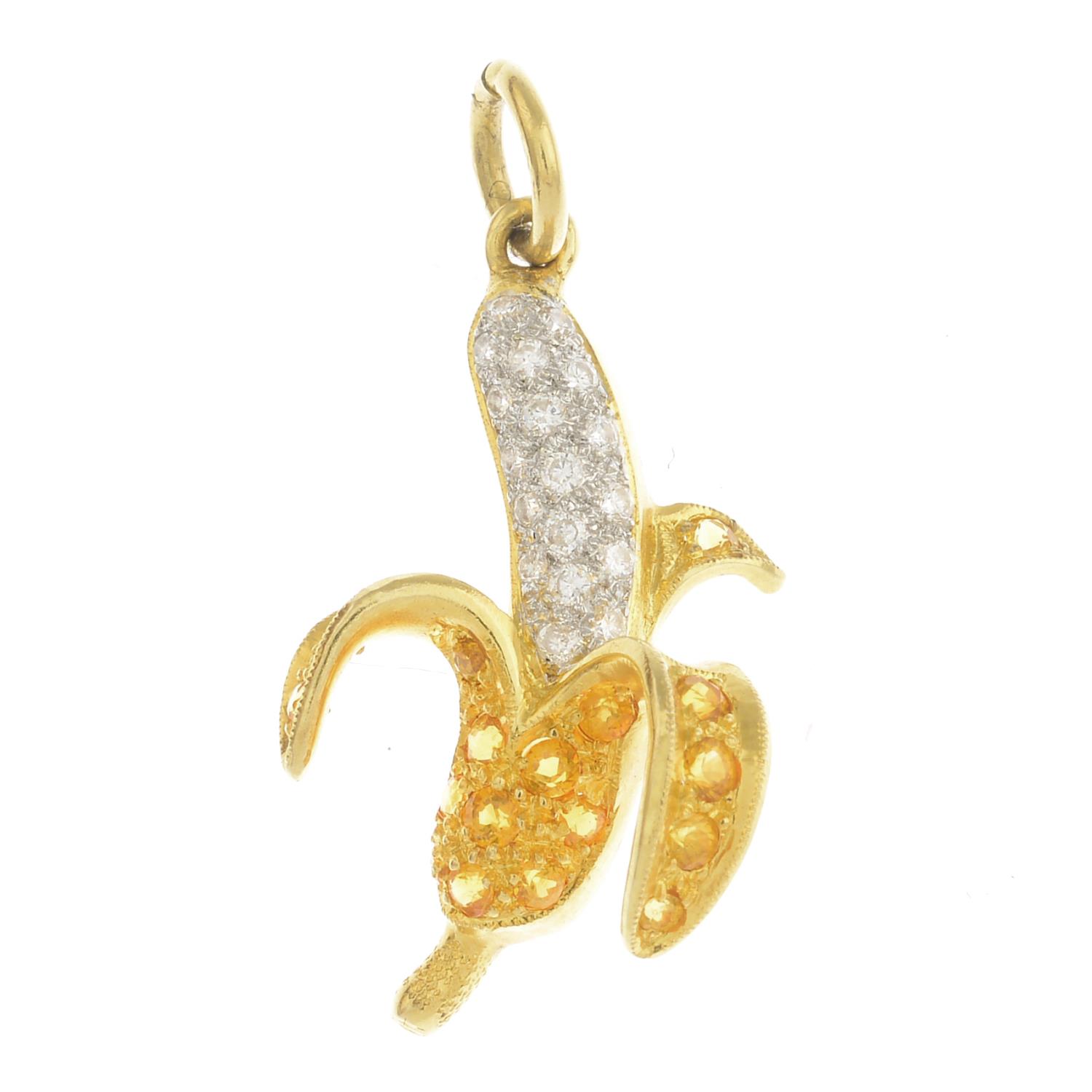 A pave-set diamond and yellow sapphire banana pendant.Estimated total diamond weight 0.15ct.Length