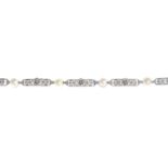 An early 20th century platinum pearl and diamond bracelet.