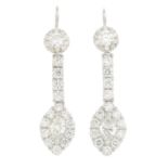 A pair of diamond earrings.Principal four diamonds estimated total weight 0.80ct,