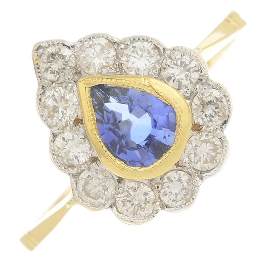 A sapphire and diamond cluster ring.Estimated total diamond weight 0.40ct.Stamped 18ct.Ring size