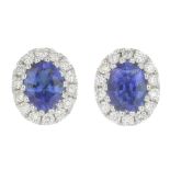 A pair of sapphire and diamond earrings.Total sapphire weight 0.61ct,