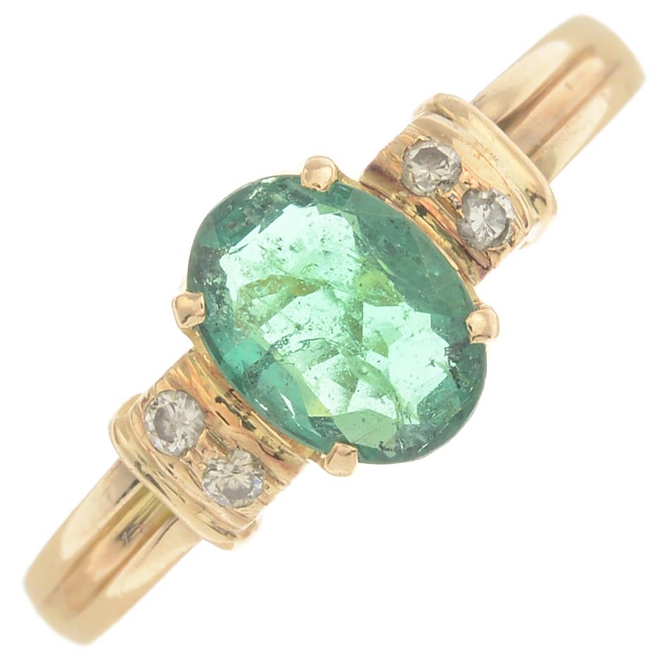 An emerald and diamond ring.Emerald calculated weight 0.70ct,