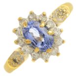 An 18ct gold sapphire and diamond cluster ring.Estimated total diamond weight 0.25ct.Hallmarks for