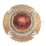 A late 19th century gold garnet and diamond brooch.