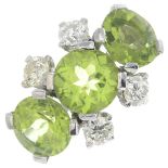 A peridot and diamond ring.Peridot total calculated weight 5.52cts,