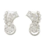 A pair of diamond floral earrings.