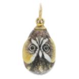 An early 20th century enamel egg pendant, painted to depict an owl.Length 2.3cms.