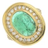 An emerald cabochon and diamond dress ring.Emerald calculated weight 3.71cts,