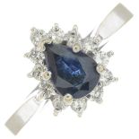 A sapphire and diamond cluster ring.Estimated total diamond weight 0.25ct.Stamped 14k.Ring size