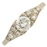 A mid 20th century platinum and gold diamond dress ring.Principal brilliant-cut diamond estimated