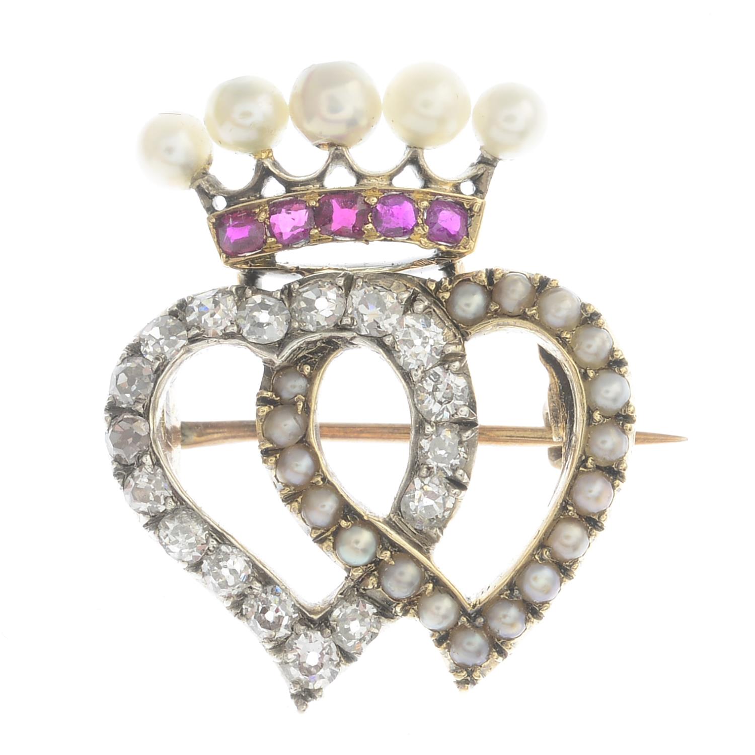 A ruby, diamond and cultured pearl brooch.Estimated total diamond weight 0.50ct.Length 2.4cms.