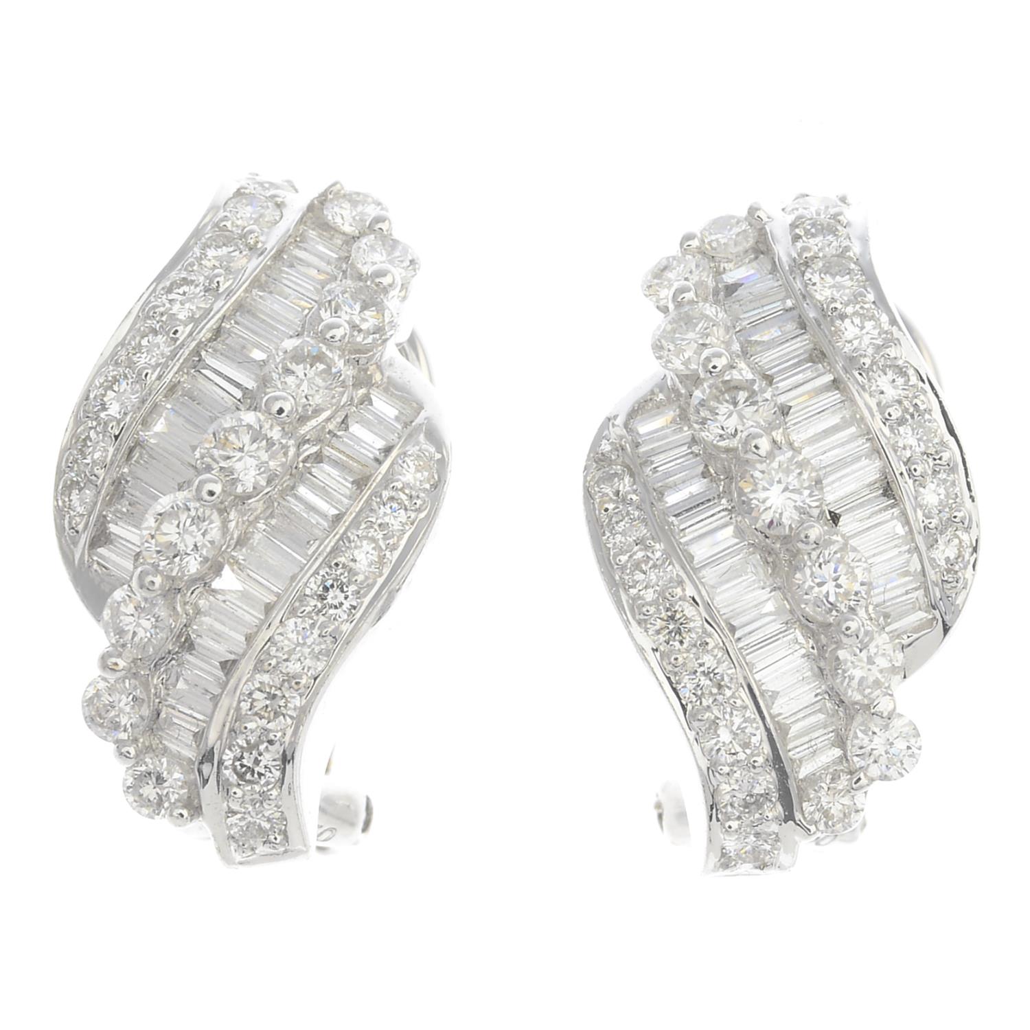 A pair of 18ct gold diamond scroll earrings.