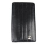 CHANEL - a black quilted long bifold wallet.