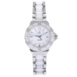 TAG HEUER - a lady's Formula 1 bracelet watch. Stainless steel case with white ceramic calibrated