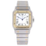 CARTIER - a mid-size Santos bracelet watch. Stainless steel case with yellow metal bezel. Numbered