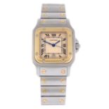 CARTIER - a mid-size Santos bracelet watch. Stainless steel case with yellow metal bezel. Numbered