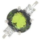 A green tourmaline and diamond three-stone ring.Tourmaline calculated weight 3.65cts,