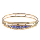 An Edwardian 9ct gold blue paste bangle.Hallmarks for Chester, 1908.