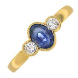 An 18ct gold sapphire and diamond three-stone ring.Calculated sapphire weight 0.85ct,