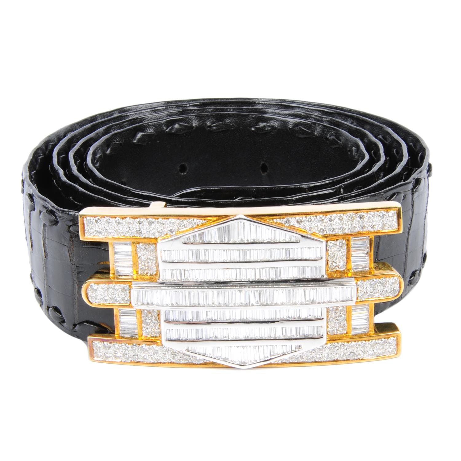 A black crocodile skin belt with calibre and pave-set diamond buckle.