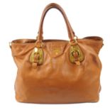 PRADA - a tan leather handbag.