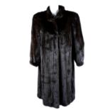 A knee-length dark ranch mink coat.