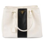 PRADA - a perforated Saffiano Fori tote.