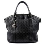 GUCCI - a black Guccissima leather handbag.