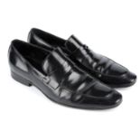 CHRISTIAN DIOR - a pair of men's black leather loafers.