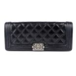 CHANEL - a black Convertible Long Le Boy Classic Flap clutch.