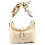 ASPREY - a cream handbag with scarf handle.