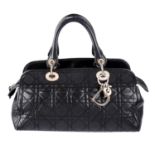 CHRISTIAN DIOR - a black leather Cannage handbag.