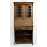 An early 20th century oak and lead glazed bureau bookcase,