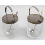 A pair of glass preserve pots and covers,