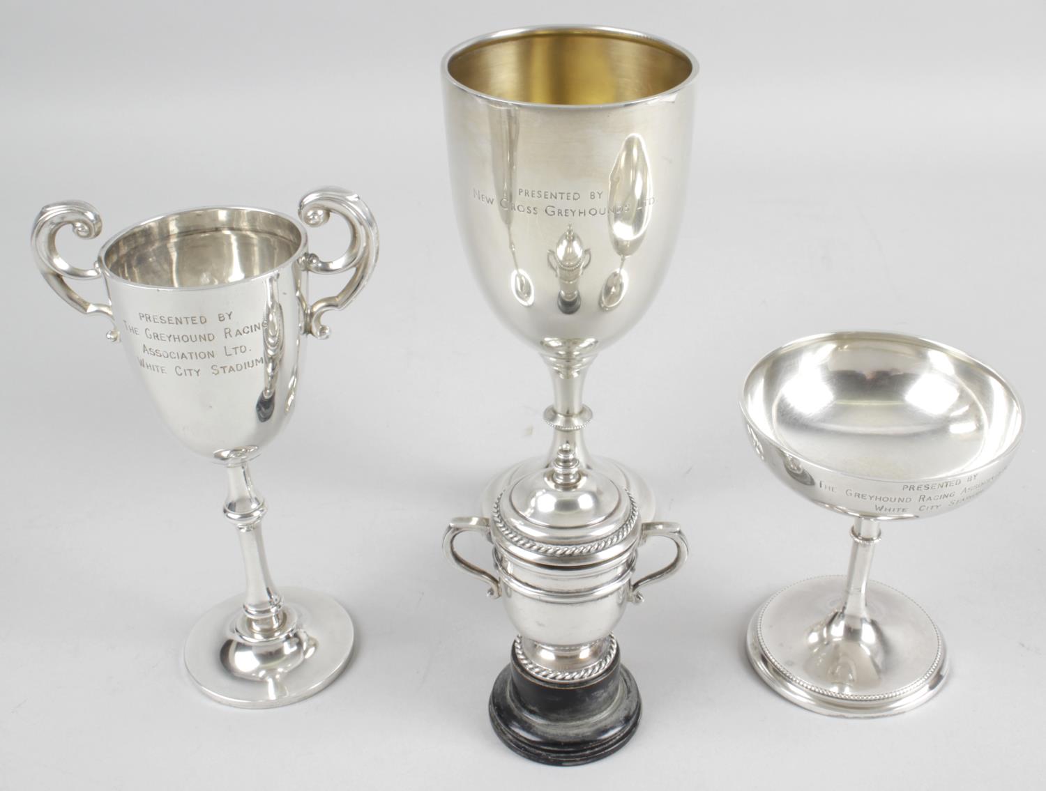 A 1930's miniature silver trophy cup and cover with twin handles and rope twist border detail,