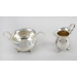 An Edwardian silver twin-handled sugar bowl and matching cream jug,