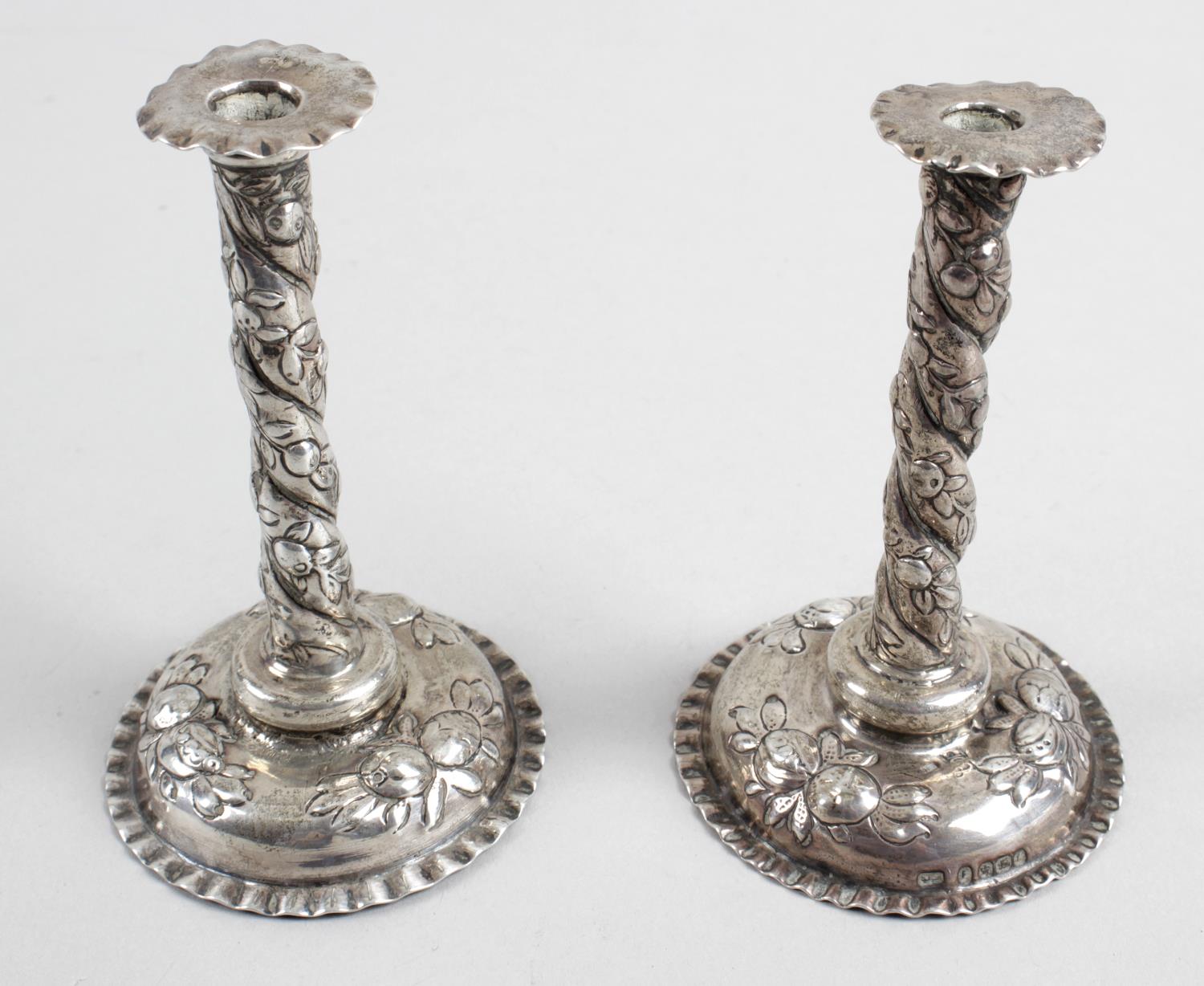 A pair of late nineteenth century small silver candlesticks,