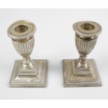 A pair of Edwardian silver mounted dwarf candlesticks,