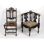 An early 20th century carved oak framed corner chair,