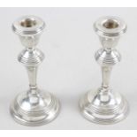 A pair of modern silver mounted candlesticks,
