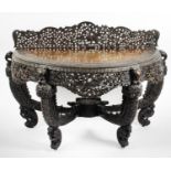 A late 19th century Burmese carved hardwood demi lune side table,