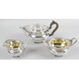 An early George V silver three piece tea service in Regency style,