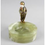 A green onyx dish of circular form mounted with an Art Deco cold painted bronze and ivory figure,