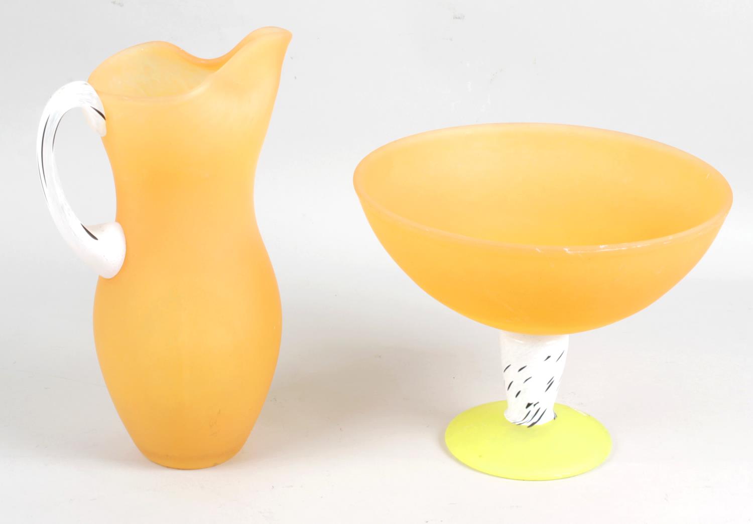 A Kosta Boda orange coloured glass jug,