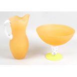 A Kosta Boda orange coloured glass jug,